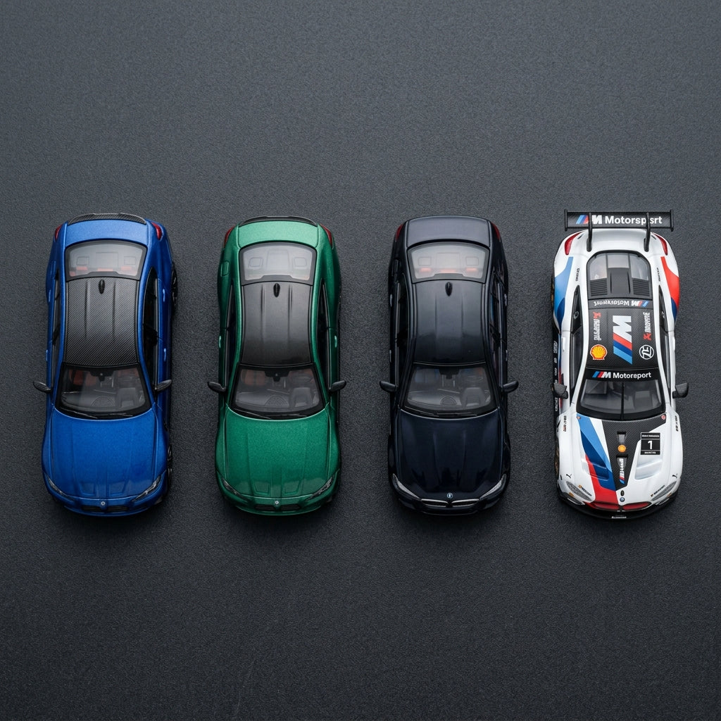 BMW diecast model cars — M3 Competition, M4 G82 in Isle of Men green, M5 and M8 GT3 race car in 1:64 scale